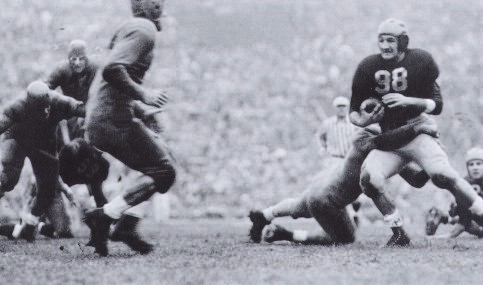 Michigan halfback Tom Harmon carrying against Minnesota in 1940