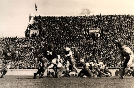 Wisconsin back Crazy Legs Hirsch carrying against Ohio State in a 1942 football game