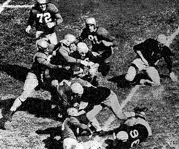 Notre Dame gang-tackling Illinois' Jules Rykovich in 1946