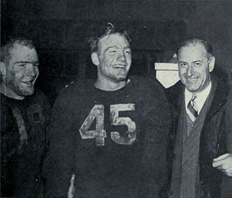 Michigan's Bump Elliott, Pete Elliott, and Fritz Crisler celebrate winning the Big 9 after defeating Wisconsin in 1947