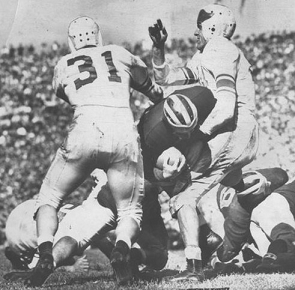 Michigan halfback Bob Chappuis carrying against Michigan State in 1947