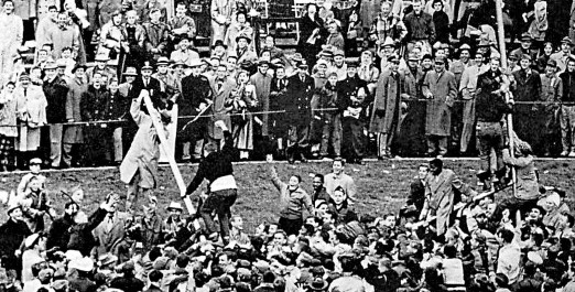 Ohio State fans tear down the goalposts after a victory over Michigan in 1954