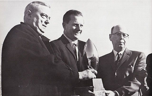 Arkansas football coach Frank Broyles receiving the Grantland Rice trophy following the 1964 season