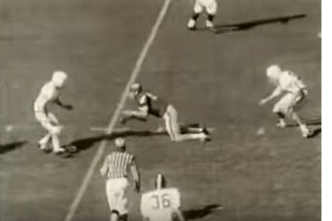 Georgia receiver lateraling in their 1965 "flea-flicker" play against Alabama, knees already down