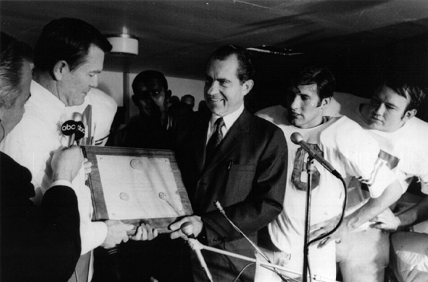 President Nixon handing Texas coach Darrell Royal a plaque declaring his team the national champion of 1969